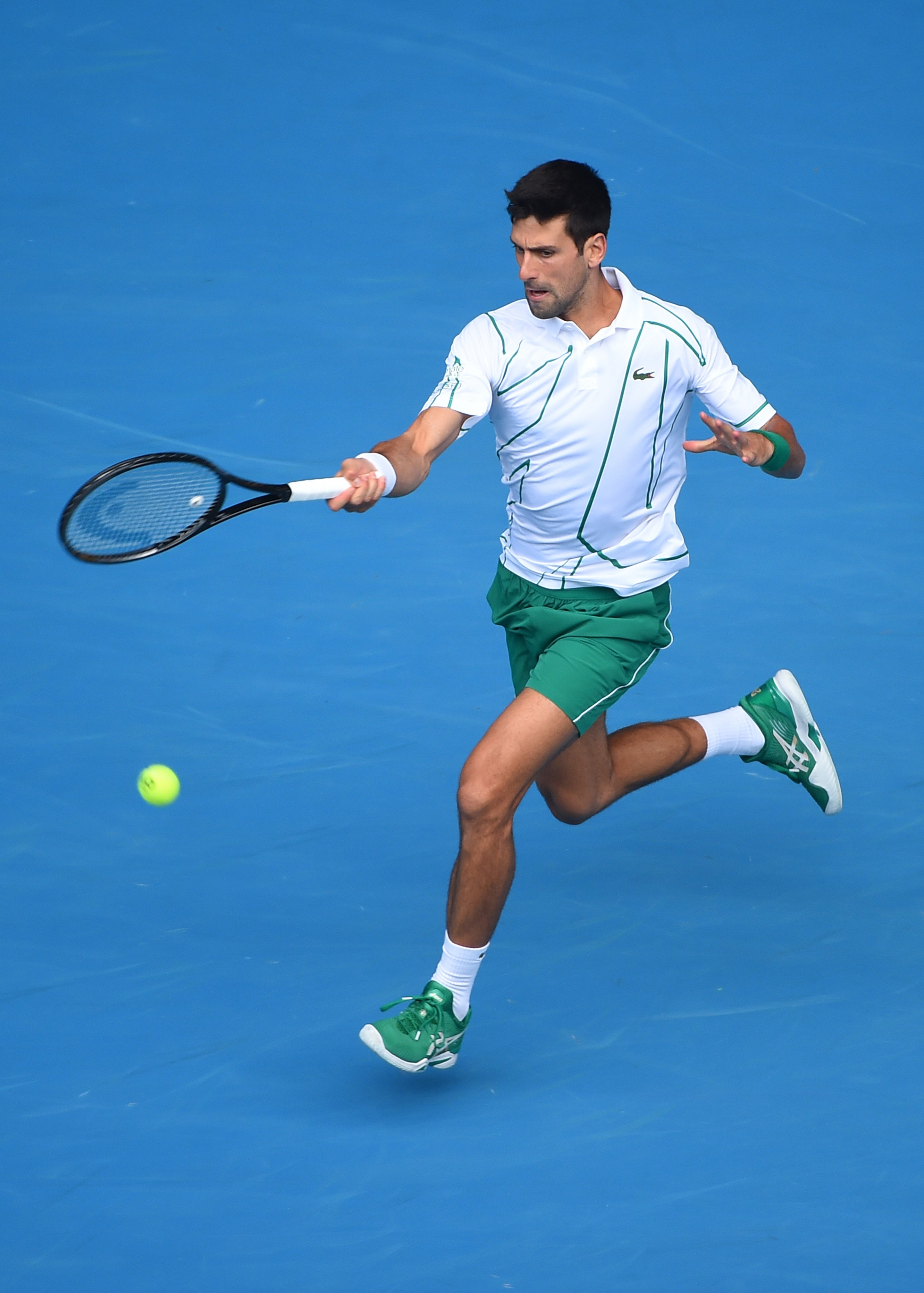 Novak in Lacoste on Blue Tennis Court